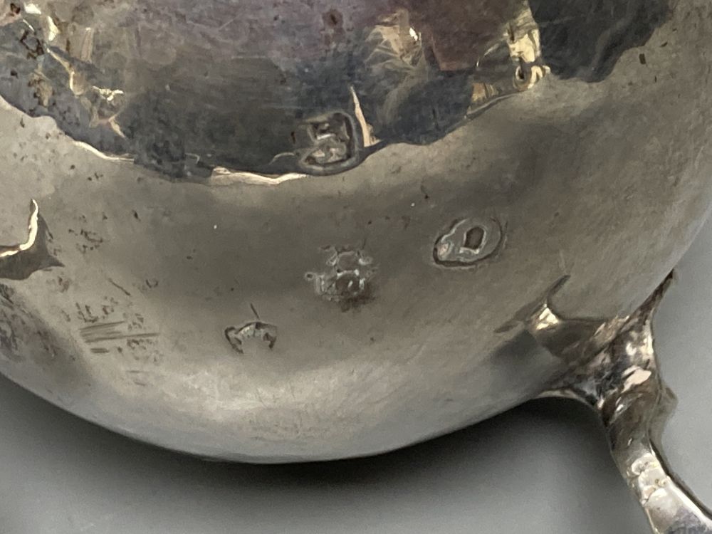 Two 18th century silver cream jugs, London, 1759 & 1768, the former with later embossed decoration,